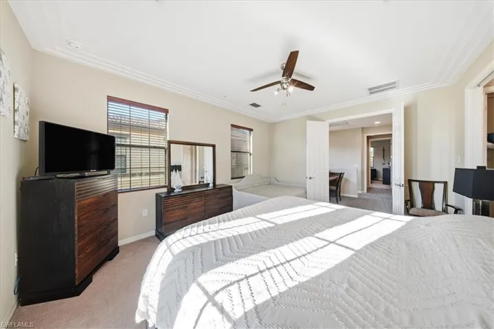Bedroom featuring light carpet and a ceiling fan