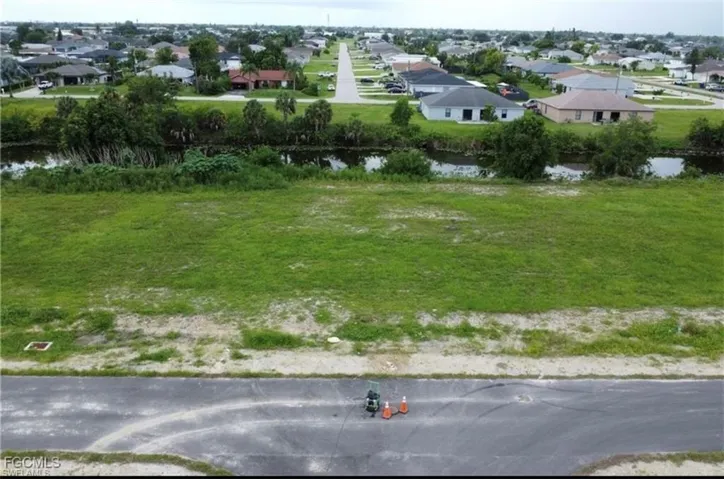 Aerial perspective of suburban area with a large body of water