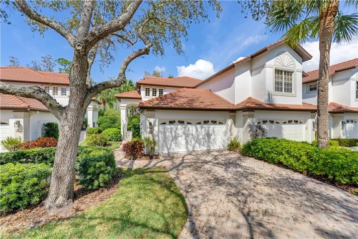 Mediterranean style coach home with private 2 car garage.