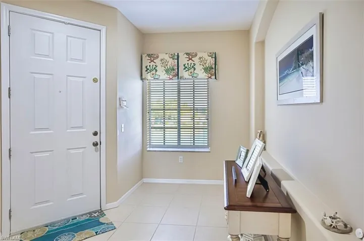 Foyer featuring baseboards and light tile patterned floors