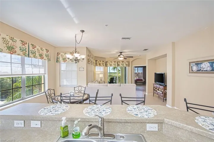 Dining space with suspended lighting and ceiling fan