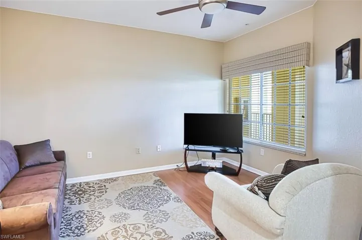 Living room with ceiling fan and wood finished floors