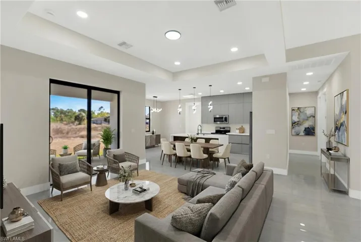 Living area with a raised ceiling and recessed lighting