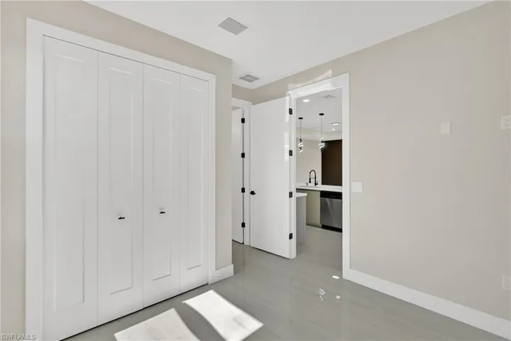 Unfurnished bedroom featuring a closet and baseboards