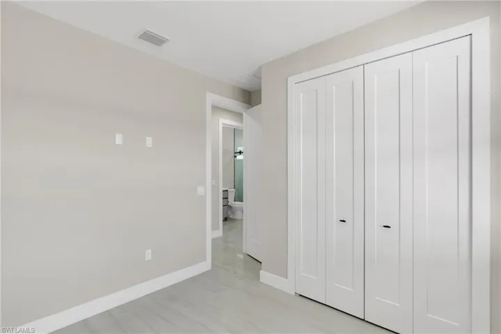 Unfurnished bedroom with baseboards and a closet