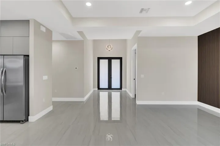 Foyer entrance with french doors and recessed lighting