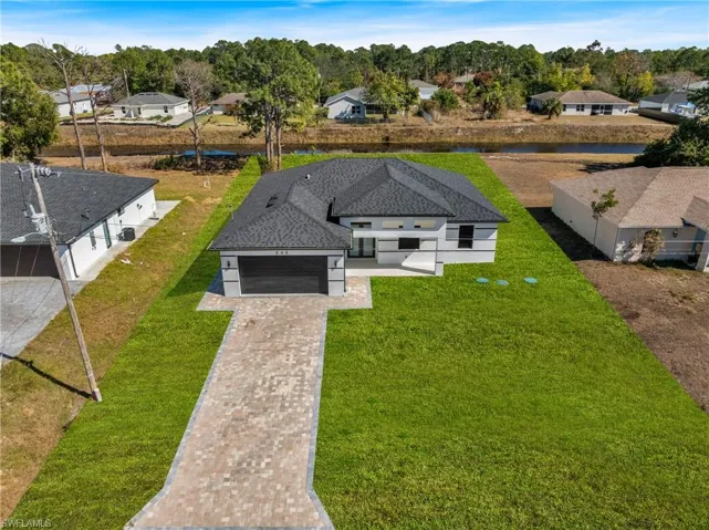 Aerial view of residential area featuring a nearby body of water