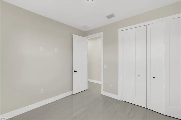 Unfurnished bedroom with baseboards and a closet