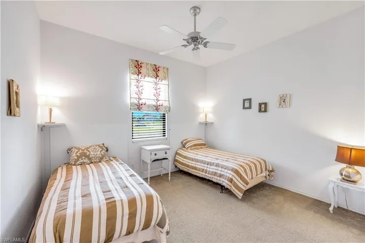 Guest bedroom 1 Carpeted bedroom with a ceiling fan and baseboards