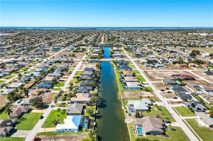 Aerial view of property's location featuring fresh water canal