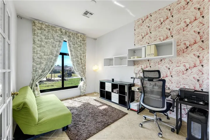 Office area featuring wallpapered walls and light tile patterned floors