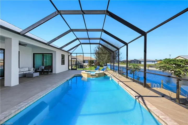 Combined pool / hot tub featuring an outdoor hangout area, a patio area, and a canal view