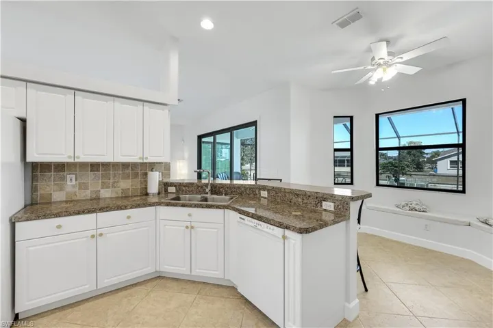 Kitchen featuring white cabinetry, a peninsula, white appliances, ceiling fan, and recessed lighting