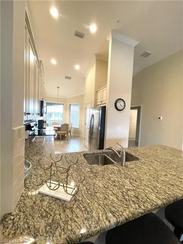 Kitchen featuring a breakfast bar area, visible vents, a sink, and appliances with stainless steel finishes