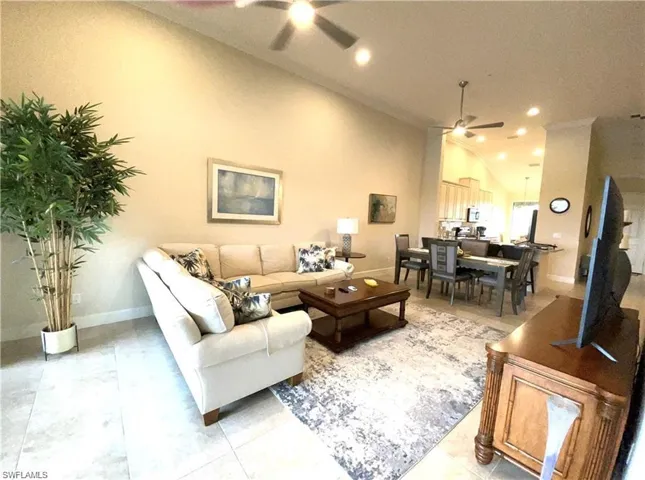Living area featuring baseboards, a ceiling fan, recessed lighting, and lofted ceiling