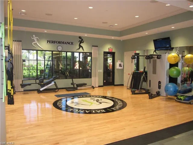 Workout area with recessed lighting, crown molding, and wood finished floors