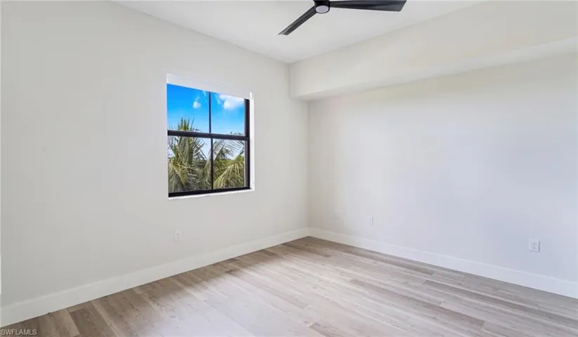Empty room featuring light wood-style flooring and a ceiling fan