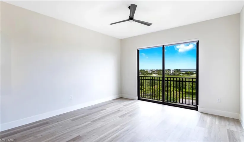 Empty room featuring light wood finished floors and a ceiling fan