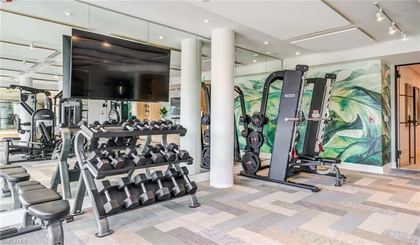 Workout area featuring carpet and track lighting