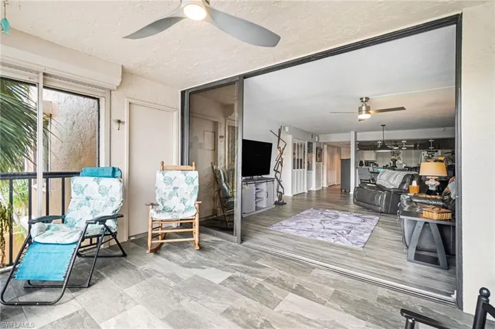 Sunroom / solarium featuring ceiling fan