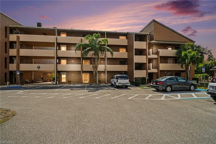 View of property featuring uncovered parking