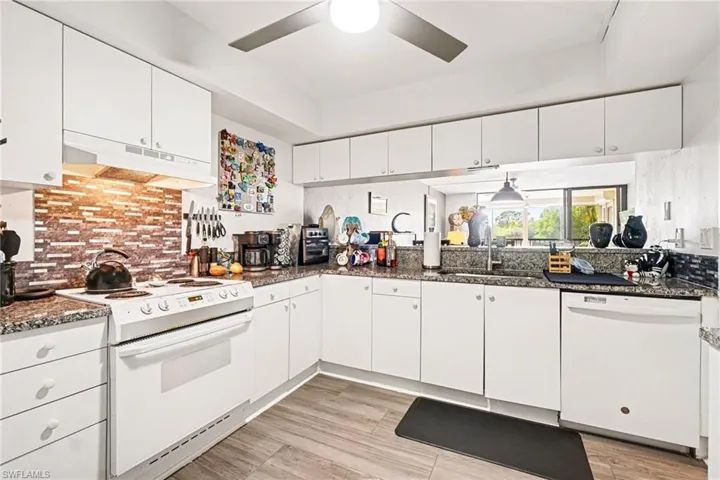 Kitchen featuring white cabinetry,