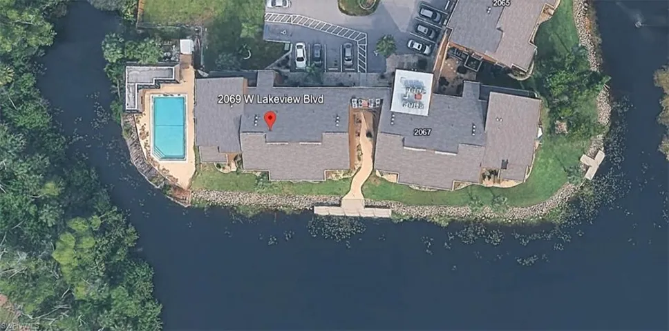 Aerial view of property's location with a nearby body of water