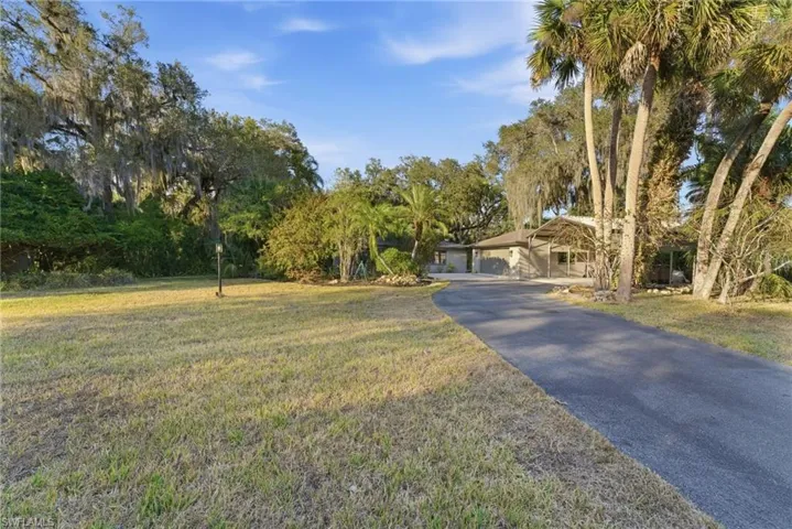 View of front facade with driveway and a front yard