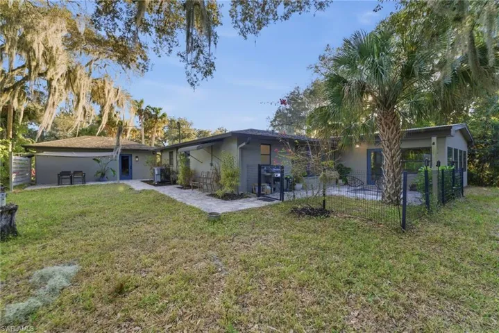 Back of house with stucco siding and a patio