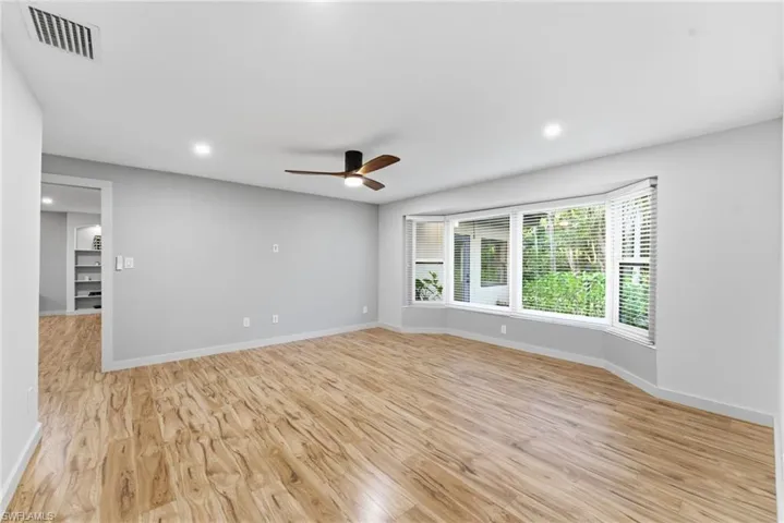 Empty room with light wood-style flooring, recessed lighting, and a ceiling fan