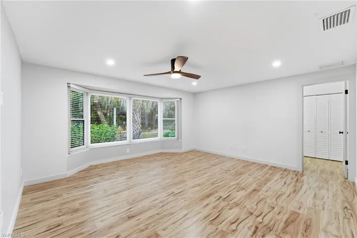 Unfurnished room with light wood-style flooring, a ceiling fan, and recessed lighting