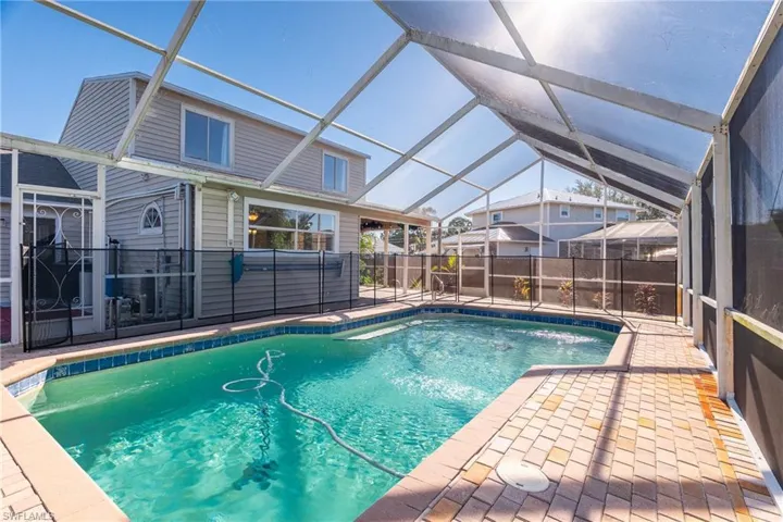 View of swimming pool with a patio and a lanai