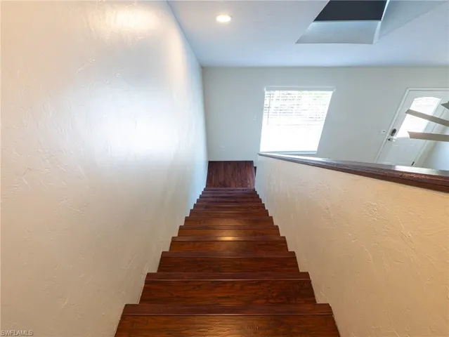 Staircase featuring wood-type flooring