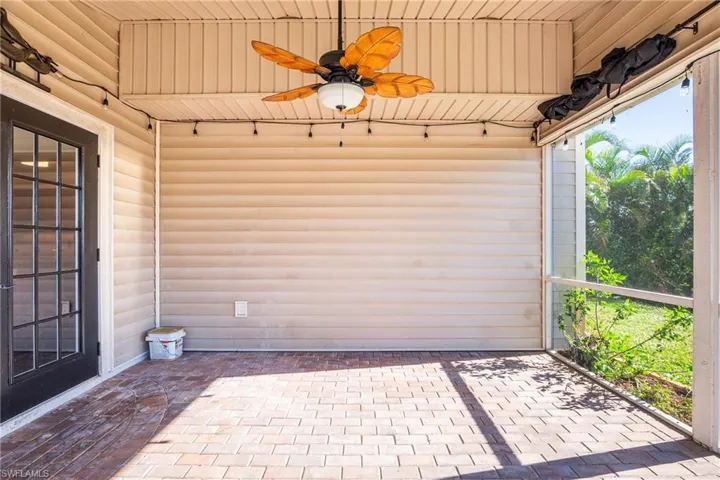 Sunroom featuring ceiling fan and wood ceiling
