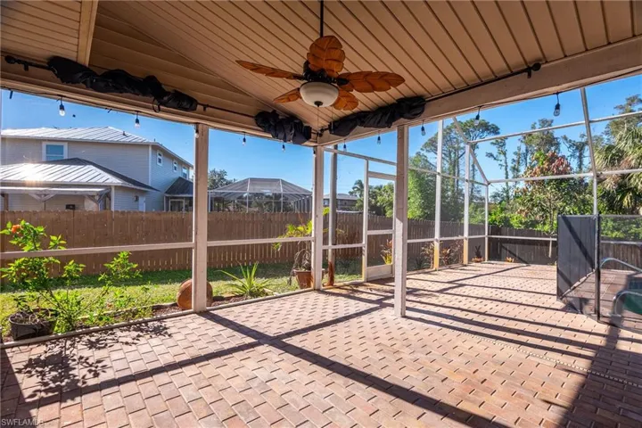 Sunroom with ceiling fan, lofted ceiling, and wood ceiling