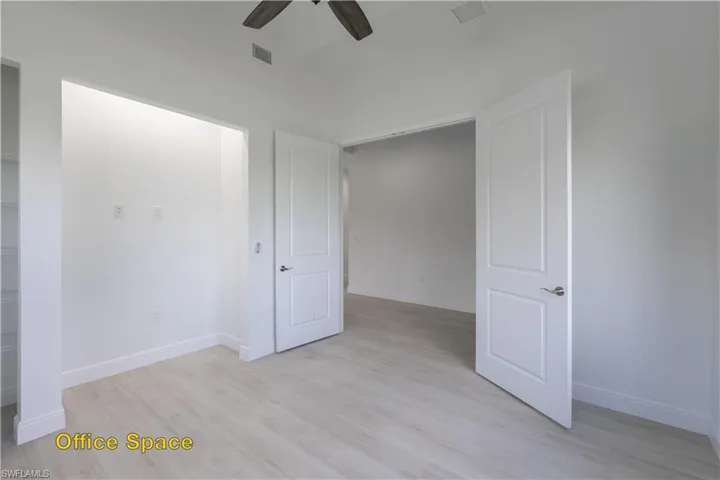 Kitchen featuring light wood-type flooring, a center island, ceiling fan, and hanging light fixtures
