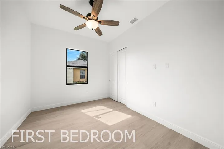Spare room featuring ceiling fan and light wood-type flooring