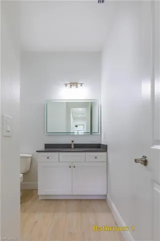 Kitchen with a healthy amount of sunlight, light stone countertops, appliances with stainless steel finishes, and a kitchen island