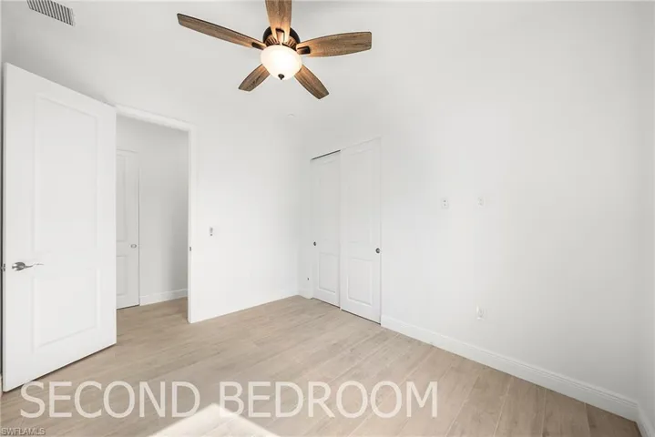 Unfurnished bedroom featuring light hardwood / wood-style flooring, ceiling fan, and a closet