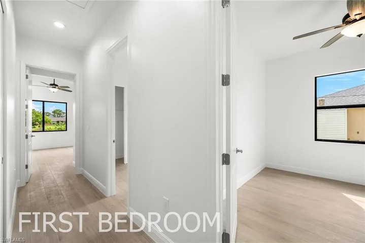 Hallway with light hardwood / wood-style flooring