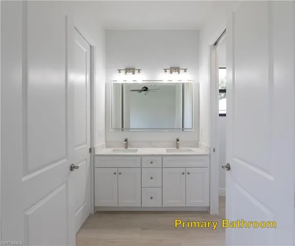 Kitchen featuring decorative light fixtures, light hardwood / wood-style flooring, gray cabinets, and vaulted ceiling
