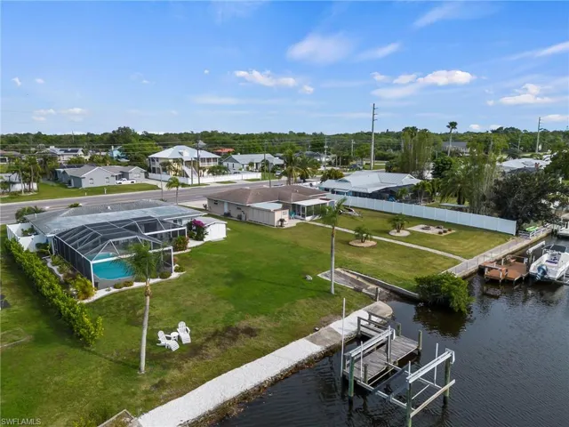 Aerial of waterside yard, shoreline and home