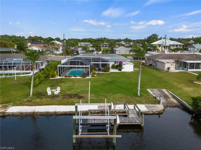 Aerial overview of home, shoreline, dock, lift and boat ramp