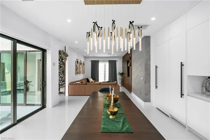 Dining area featuring an accent wall and recessed lighting