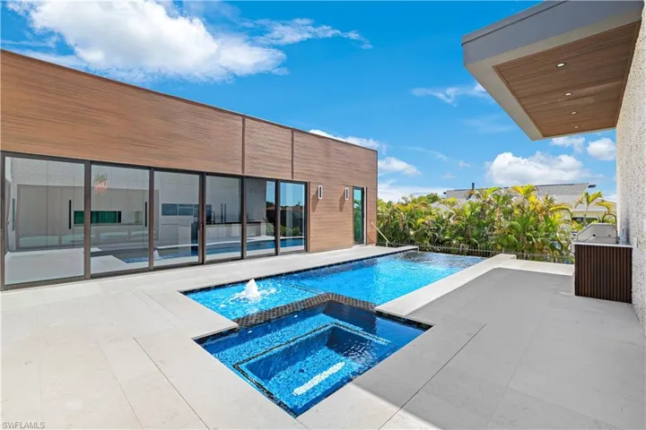 Pool featuring a patio area and an in ground hot tub