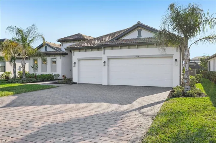 View of front of home featuring a garage and a front yard