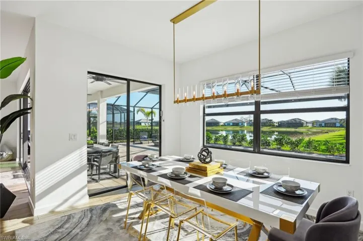Dining room featuring a water view, ceiling fan, and light hardwood / wood-style flooring