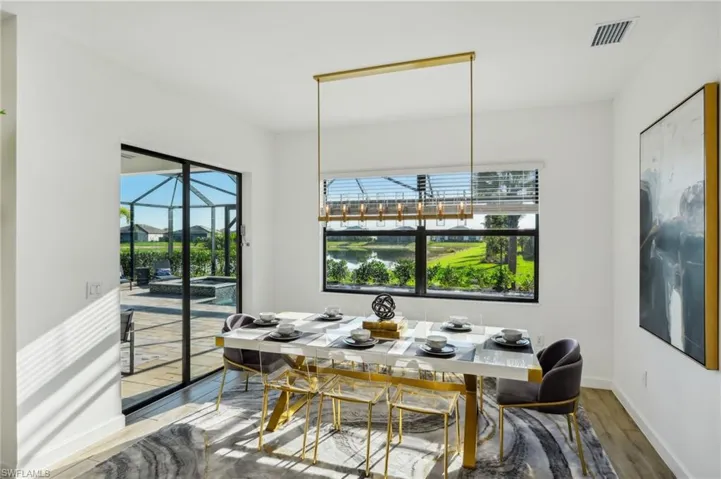 Dining space featuring hardwood / wood-style flooring and a water view