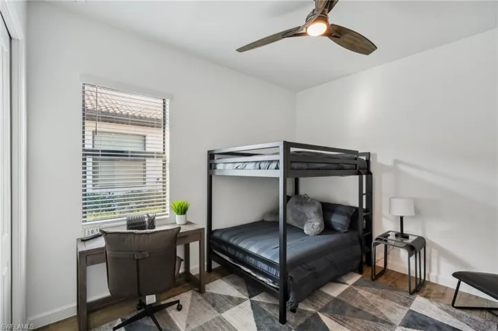 Bedroom featuring ceiling fan and wood-type flooring