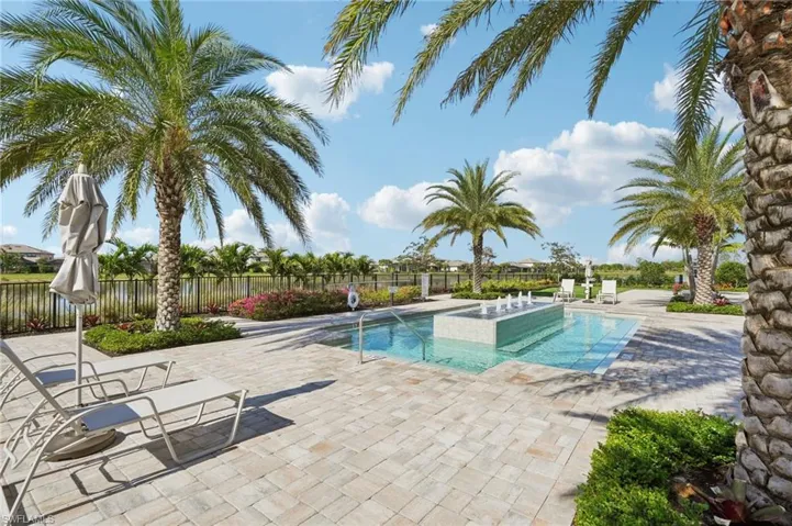 View of swimming pool with a jacuzzi and a patio